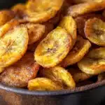 Delicious air fryer banana chips in a bowl, a healthy snack option.