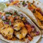 Minute Air Fryer Cod Tacos served on a plate with fresh toppings